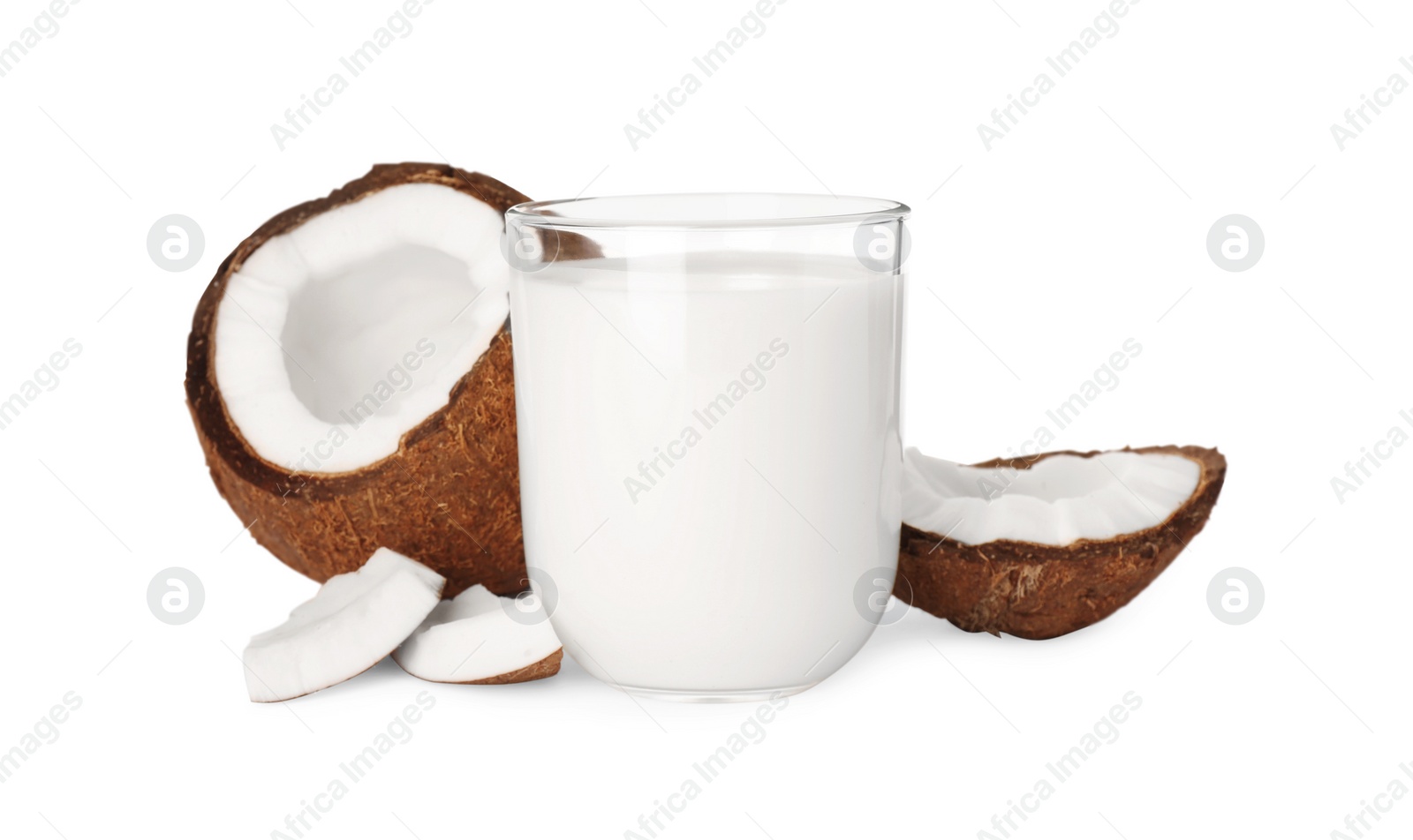 Photo of Glass of delicious vegan milk and coconut pieces on white background