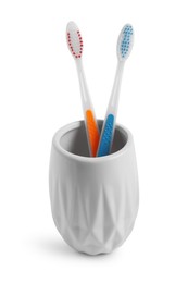 Photo of Bath accessories. Toothbrushes in holder isolated on white
