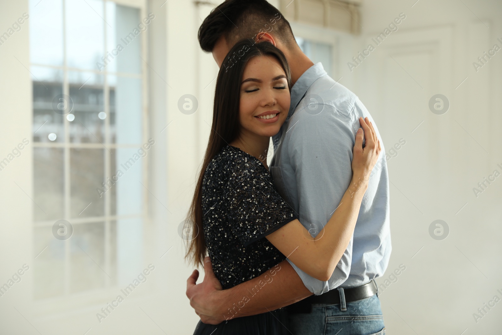 Photo of Lovely young couple dancing together in ballroom