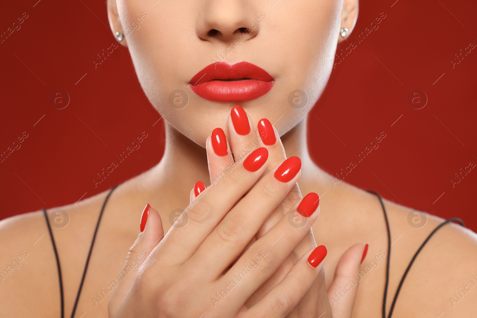 Photo of Beautiful young woman with bright manicure on color background, closeup. Nail polish trends