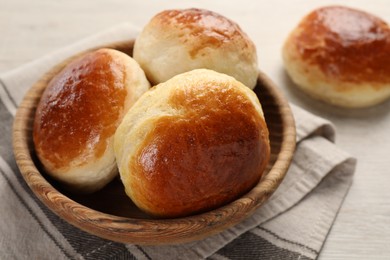 Photo of Freshly baked soda water scones on white wooden table, closeup