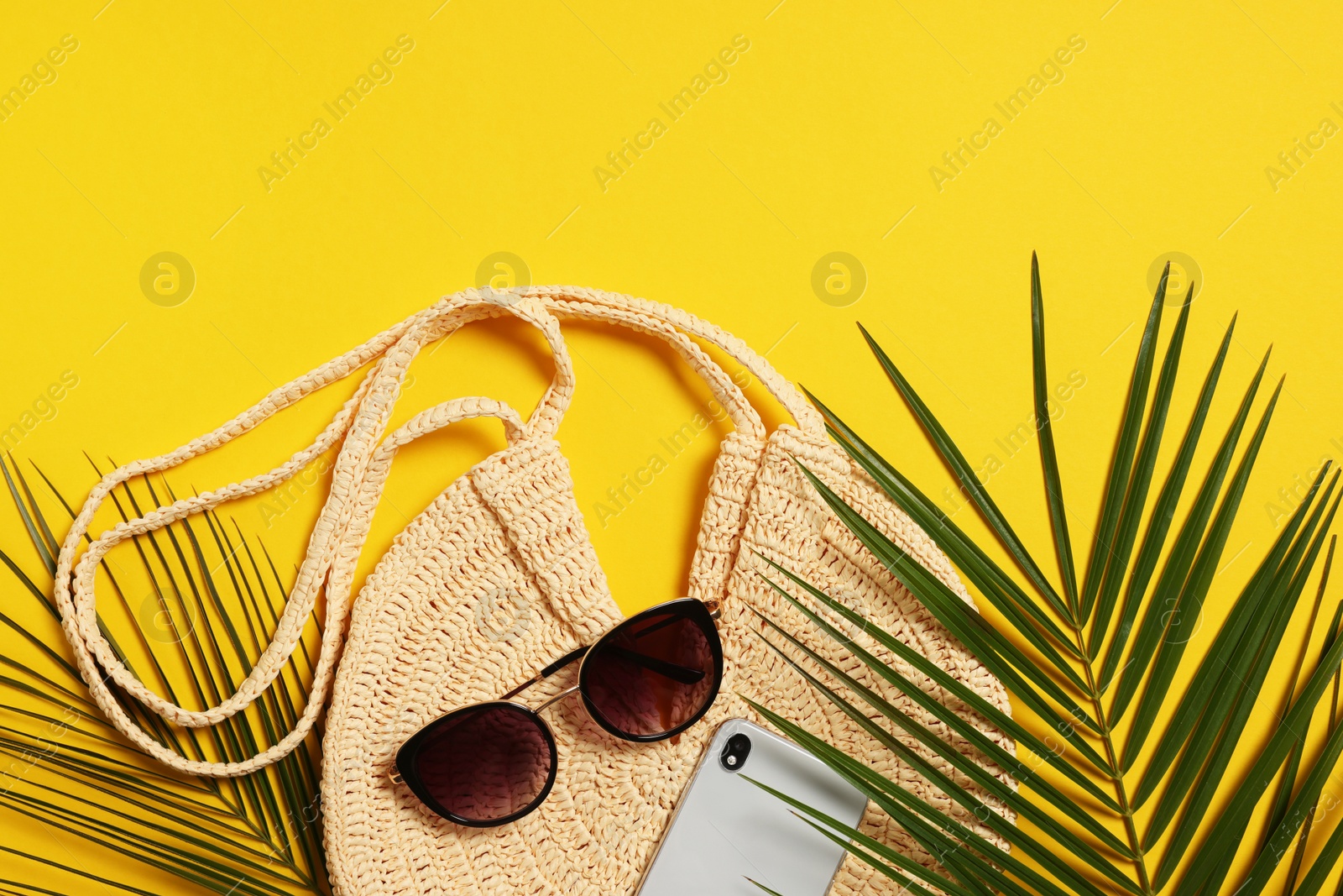 Photo of Flat lay composition with beach bag on orange background. Space for text