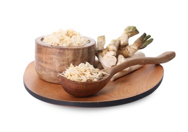 Photo of Board with grated horseradish, cut roots and spoon isolated on white