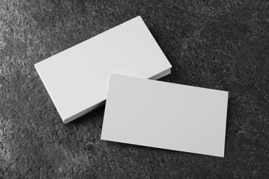 Photo of Blank business cards on grey table, above view. Mockup for design