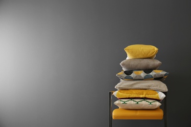 Photo of Chair with many different pillows and space for text on color background