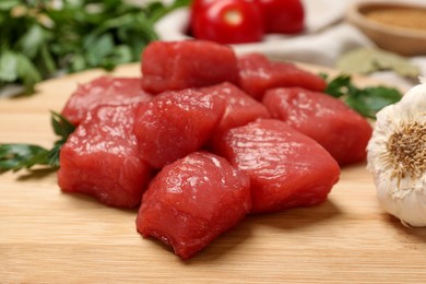 Cooking delicious goulash. Raw beef meat on wooden table, closeup