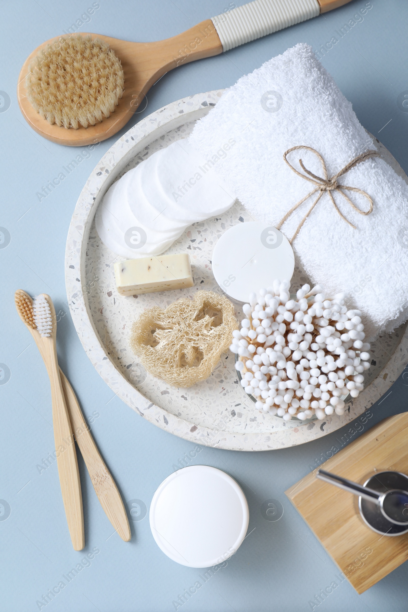 Photo of Bath accessories. Flat lay composition with personal care products on light blue background