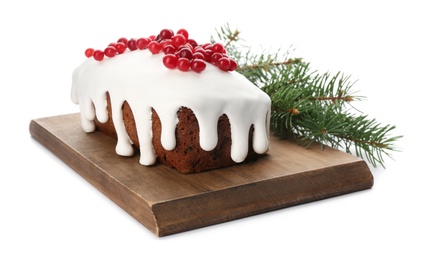 Traditional classic Christmas cake decorated with cranberries near fir tree branch isolated on white