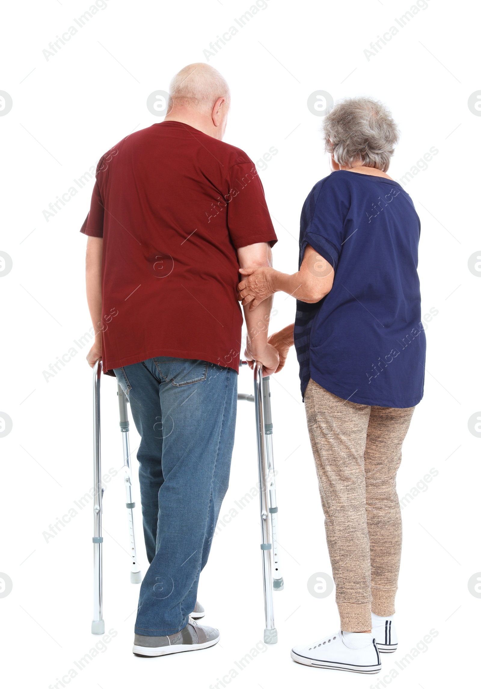 Photo of Elderly woman helping her husband with walking frame on white background