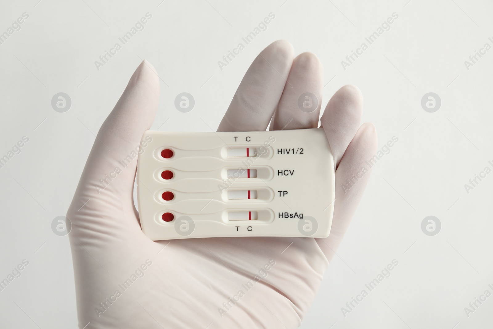 Photo of Doctor holding disposable express test for hepatitis on white background, closeup