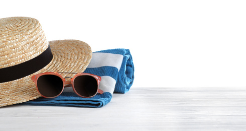 Photo of Different beach objects on wooden table against white background. Space for text