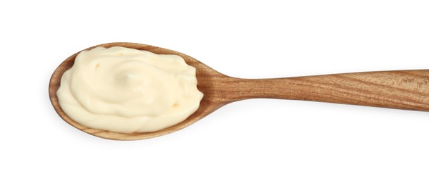 Photo of Fresh mayonnaise sauce in wooden spoon isolated on white, top view