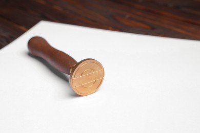 Photo of One stamp tool and sheet of paper on table, closeup. Space for text