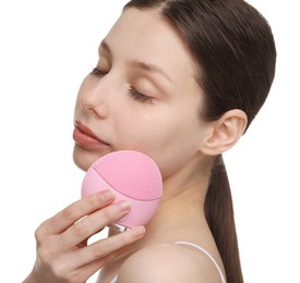 Photo of Washing face. Young woman with cleansing brush on white background