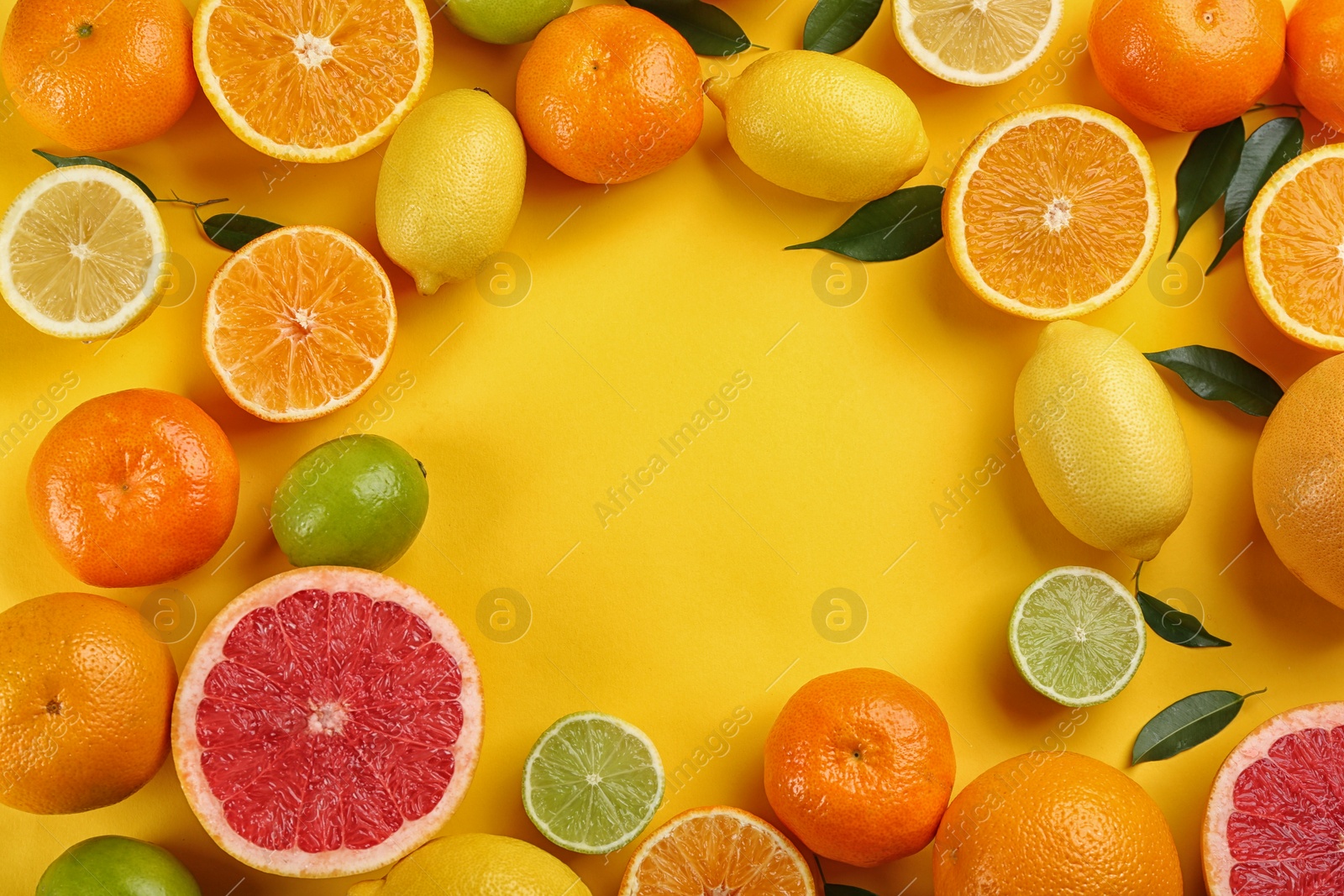 Photo of Flat lay composition with tangerines and different citrus fruits on yellow background. Space for text