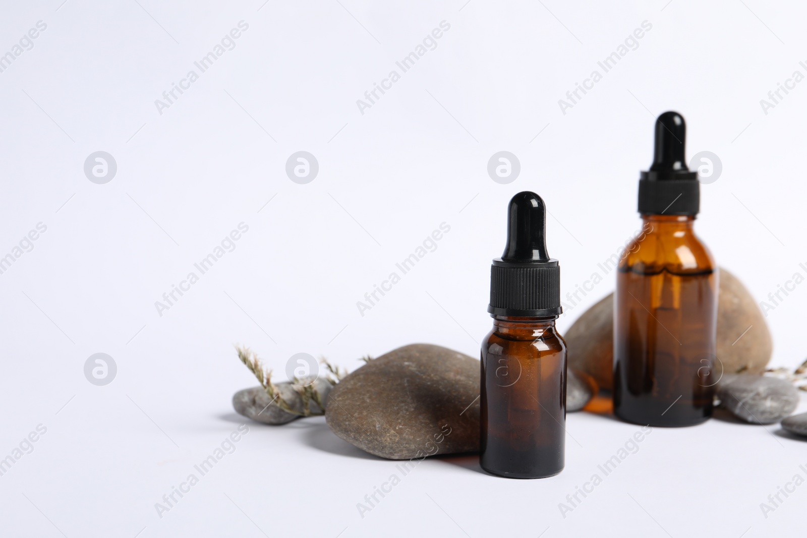 Photo of Composition with bottles of cosmetic serum on white background. Space for text