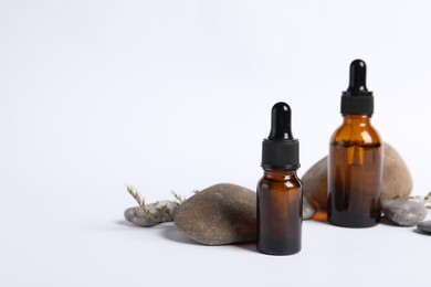 Composition with bottles of cosmetic serum on white background. Space for text