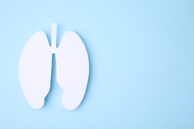 Photo of No smoking concept. Paper lungs on light blue background, top view with space for text