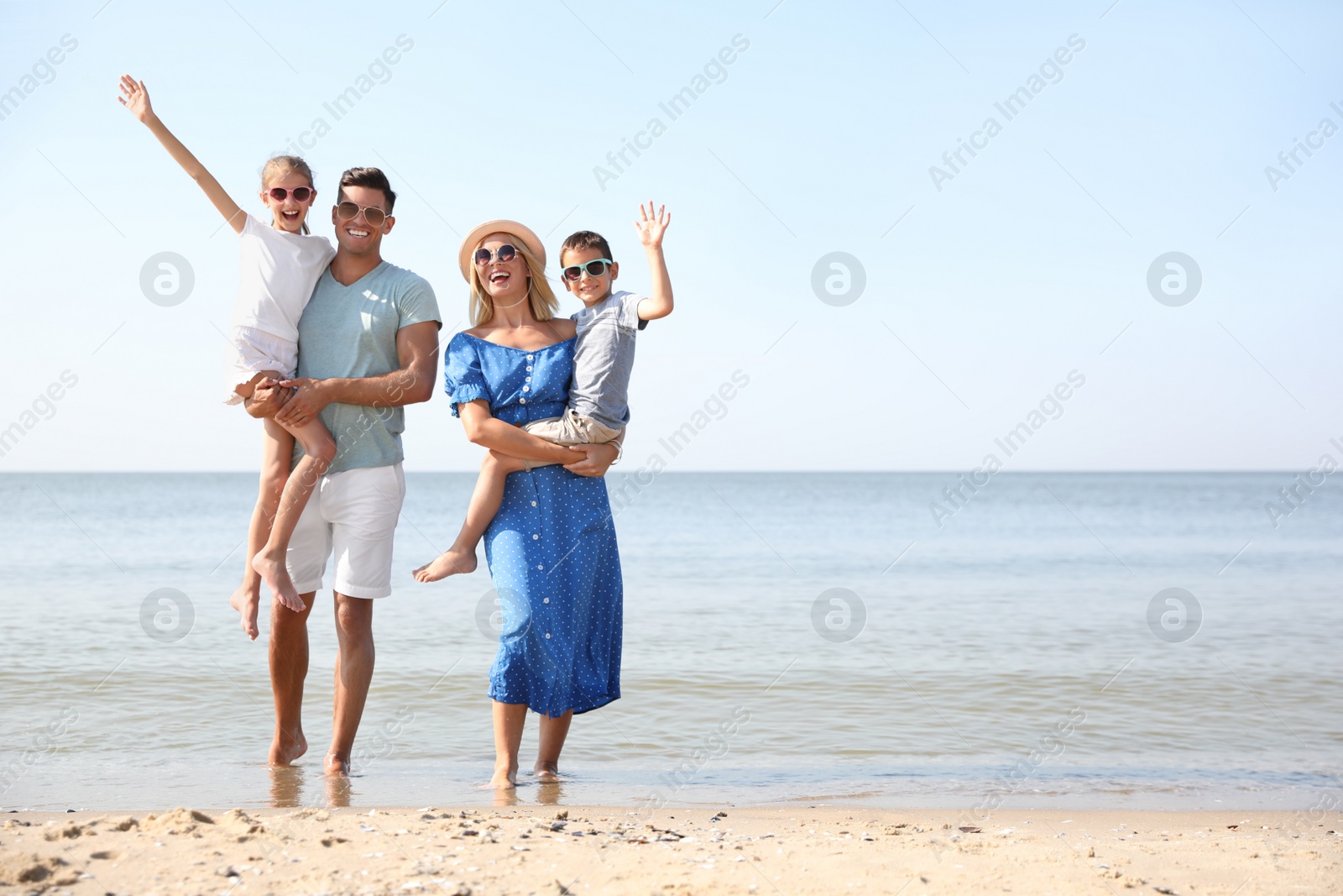 Photo of Happy family at beach on sunny summer day