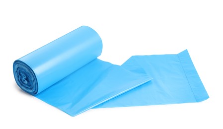 Roll of turquoise garbage bags on white background. Cleaning supplies