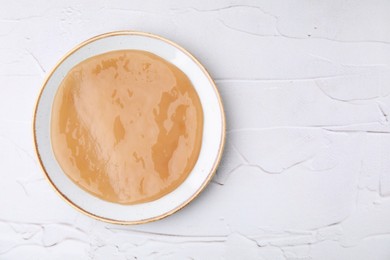 Photo of Making kombucha. Scoby fungus on white textured table, top view. Space for text