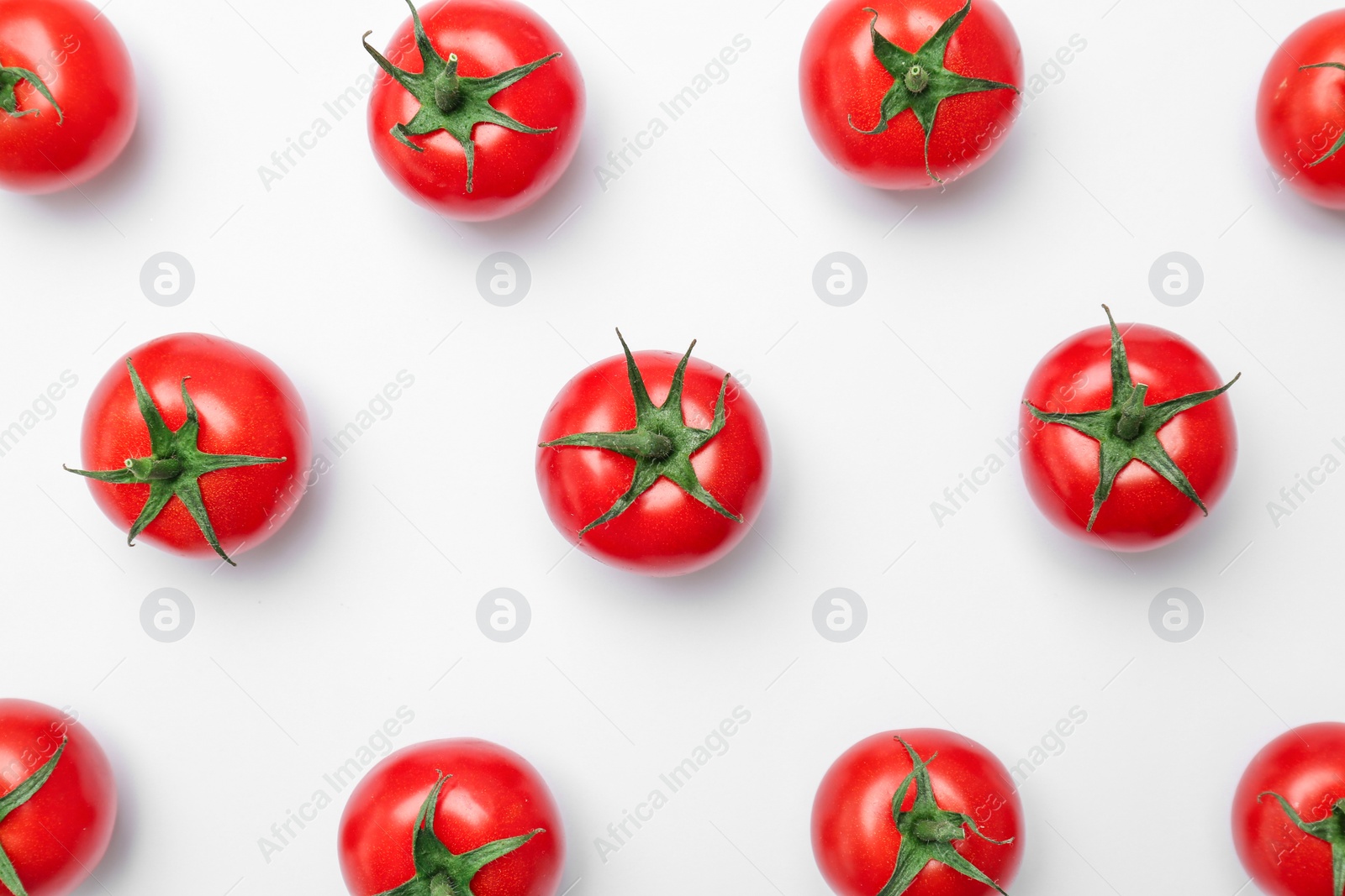 Photo of Flat lay composition with ripe tomatoes on light background