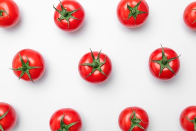 Flat lay composition with ripe tomatoes on light background