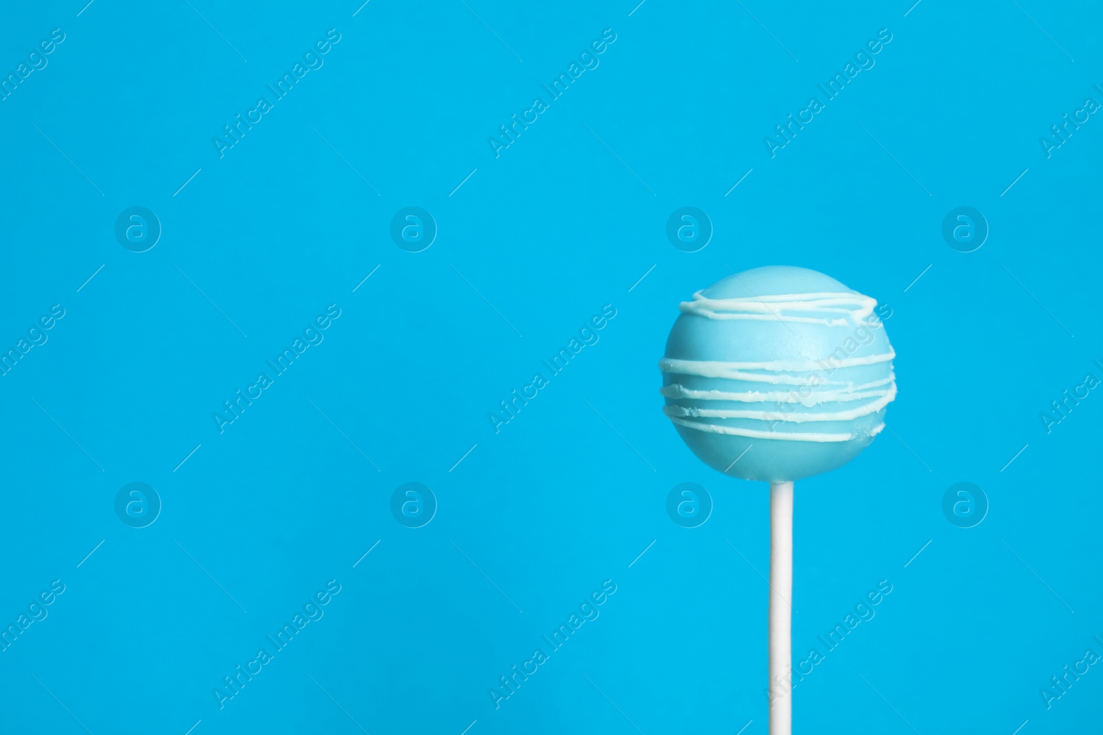 Photo of Bright delicious cake pop on color background. Space for text