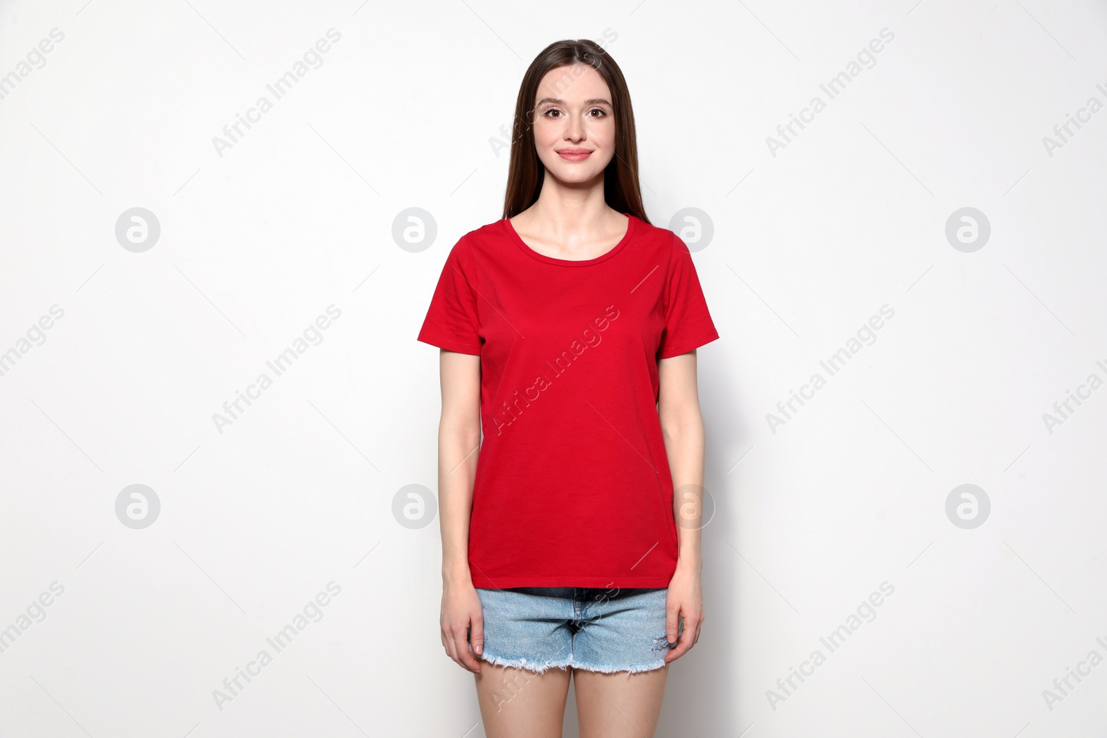 Photo of Young woman in t-shirt on light background. Mock up for design