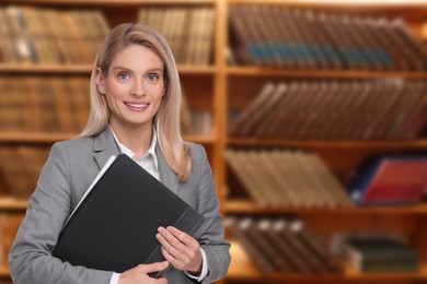 Lawyer, consultant, business owner. Confident woman with file folder smiling indoors, space for text