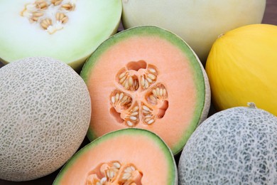 Photo of Different types of tasty ripe melons as background, closeup