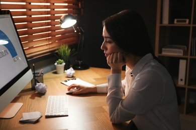 Businesswoman stressing out at workplace late in evening