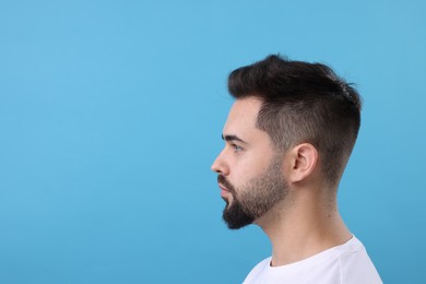 Photo of Man with healthy hair on light blue background, space for text