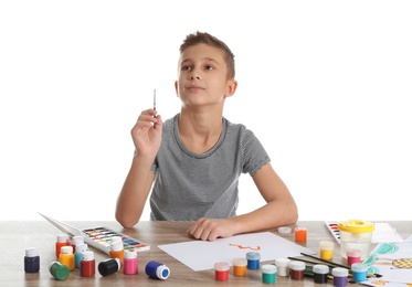 Cute child painting picture at table on white background