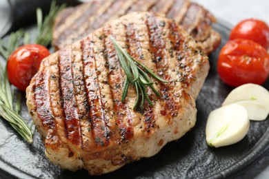 Photo of Delicious grilled pork steaks with spices on table, closeup