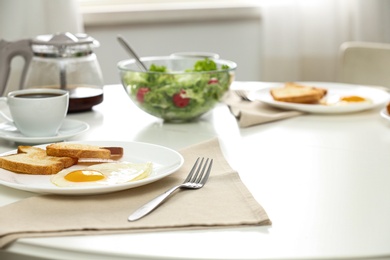 Tasty breakfast served on table in light room