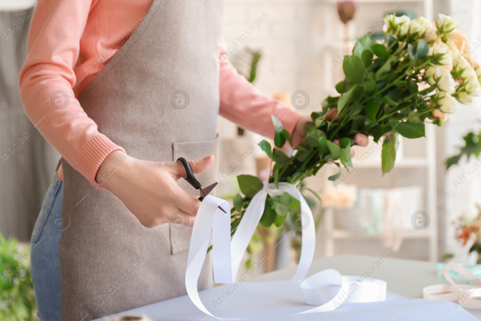 Photo of Female florist creating bouquet at workplace