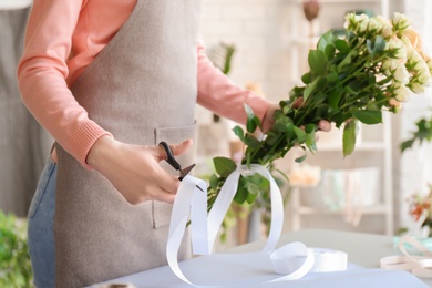 Female florist creating bouquet at workplace