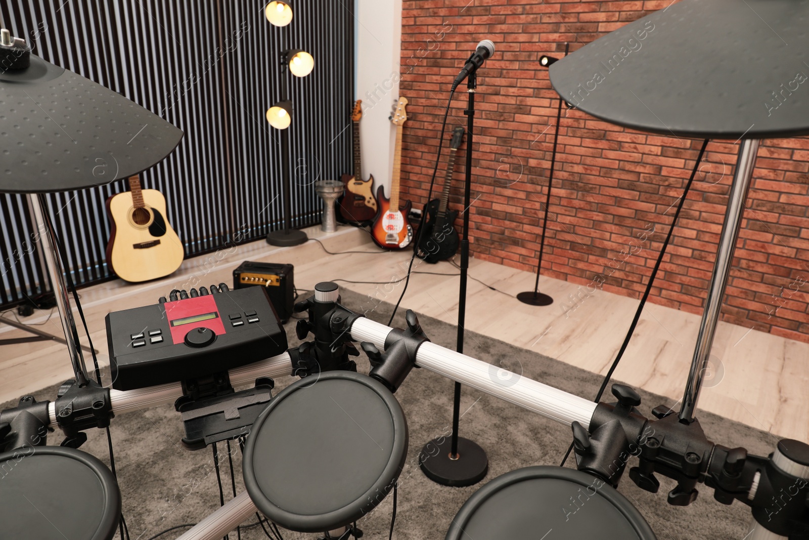 Photo of Modern music studio with microphone and different electronic instruments