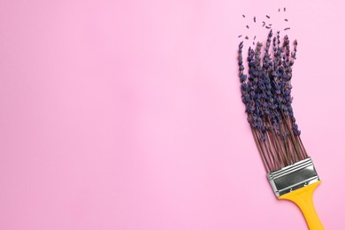Photo of Creative flat lay composition with paint brush and lavender flowers on pink background. Space for text