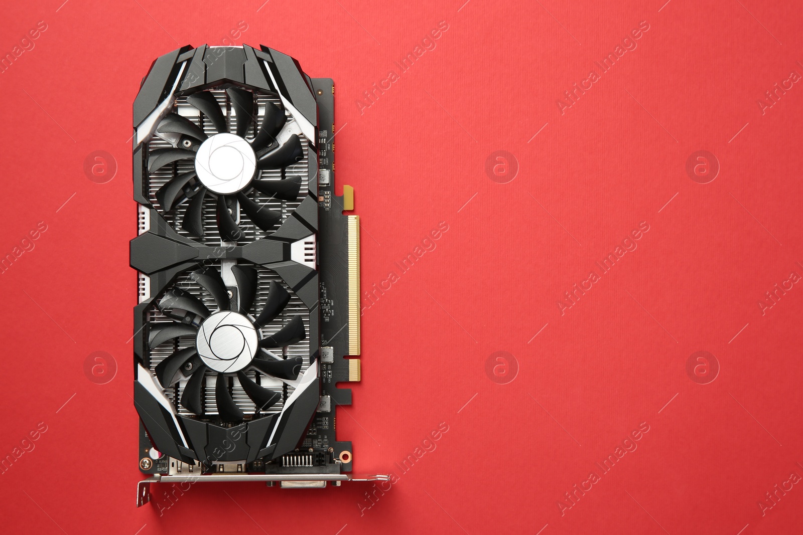 Photo of Computer graphics card on red background, top view. Space for text