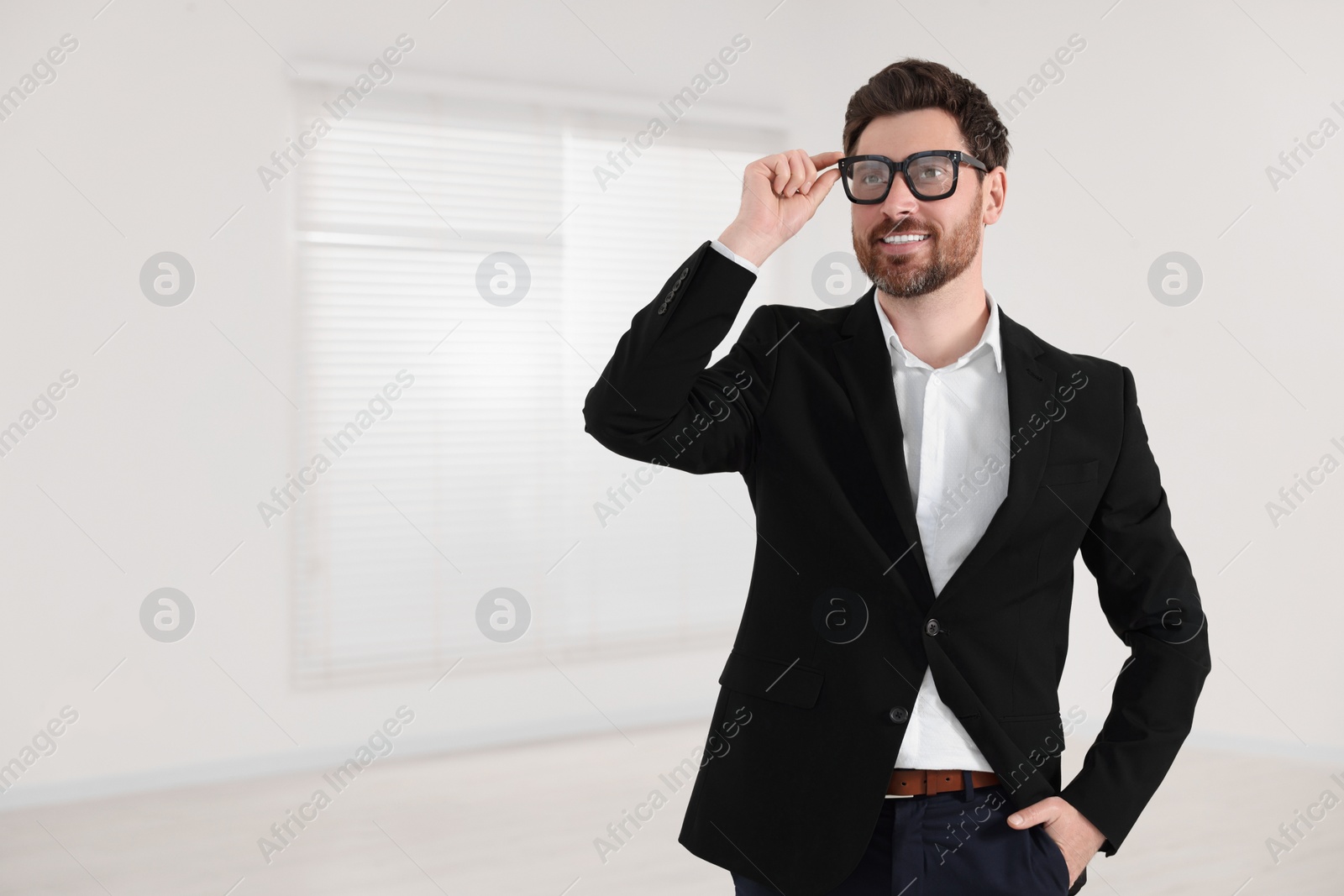 Photo of Happy real estate agent in new apartment. Space for text