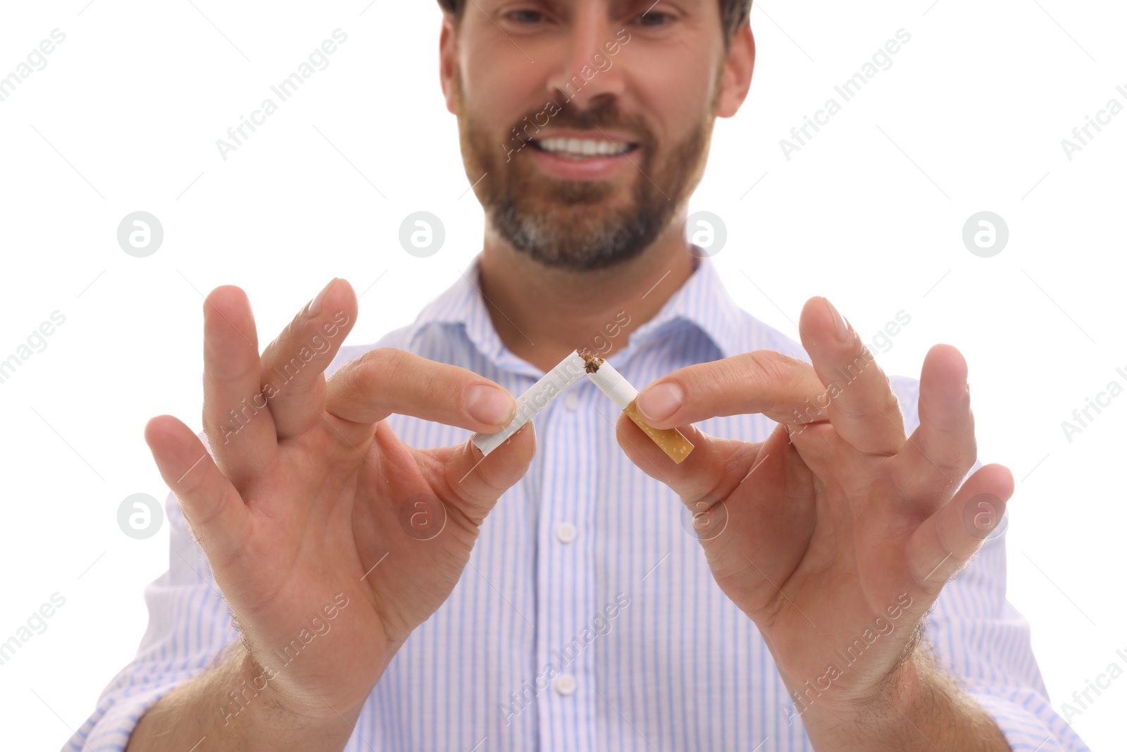 Photo of Stop smoking concept. Man breaking cigarette on white background, closeup