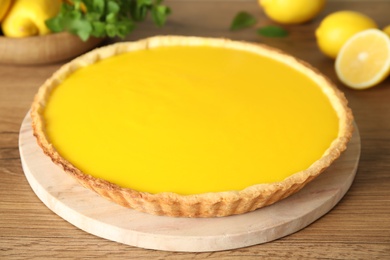 Photo of Delicious homemade lemon pie on wooden table