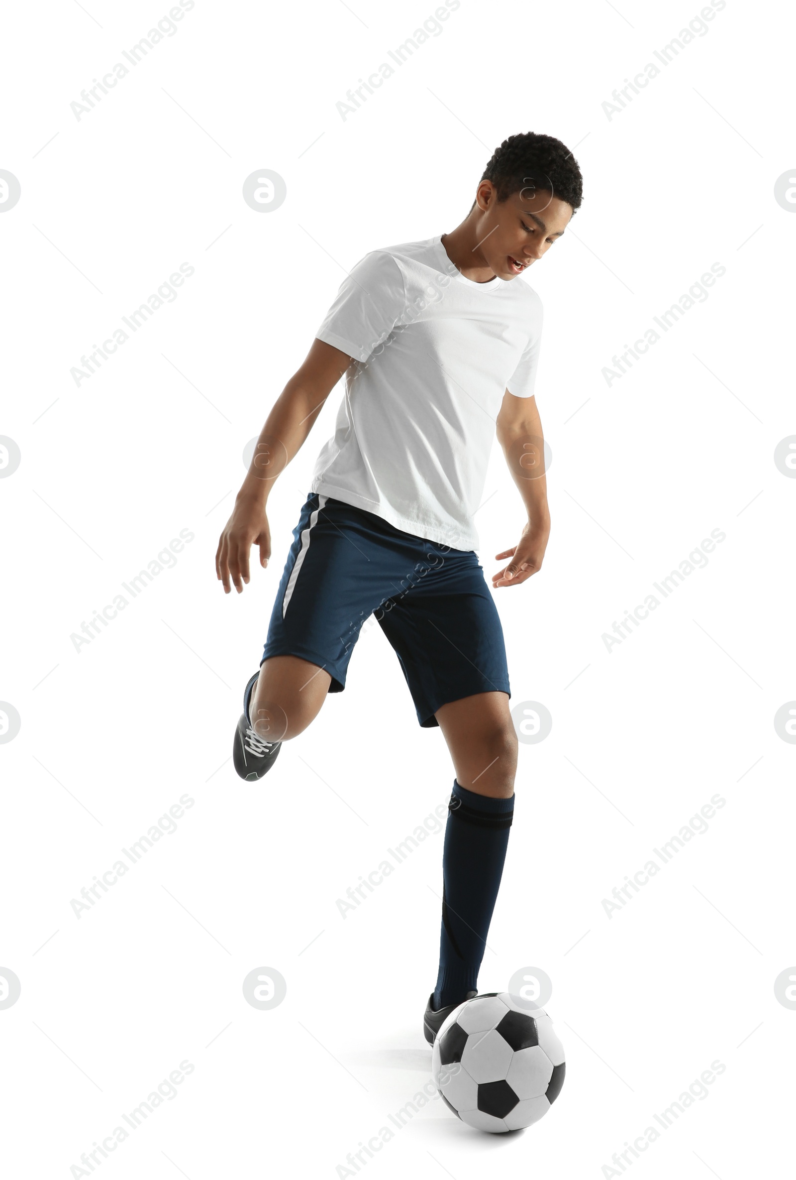 Photo of Teenage African-American boy playing football on white background