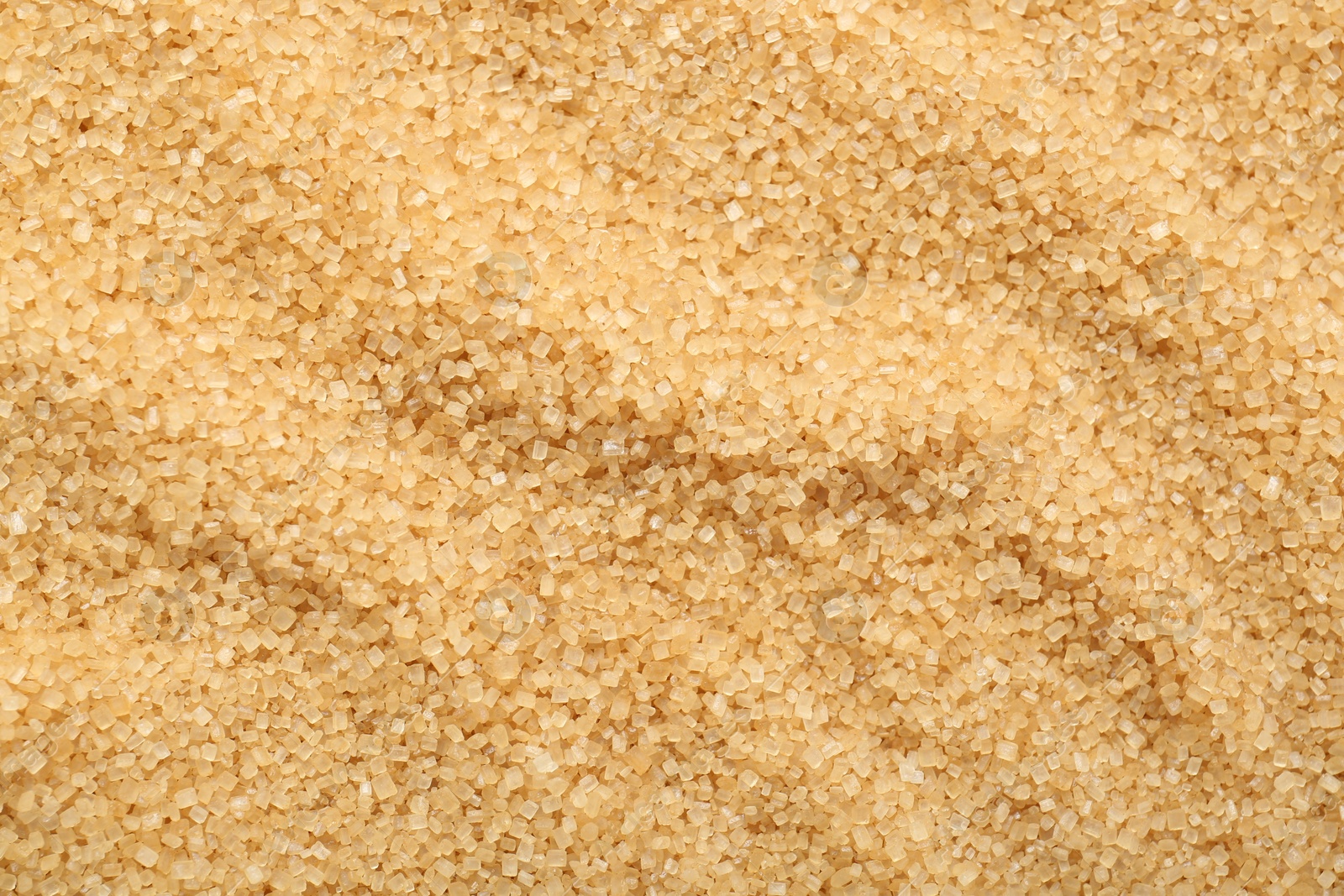 Photo of Granulated brown sugar as background, top view