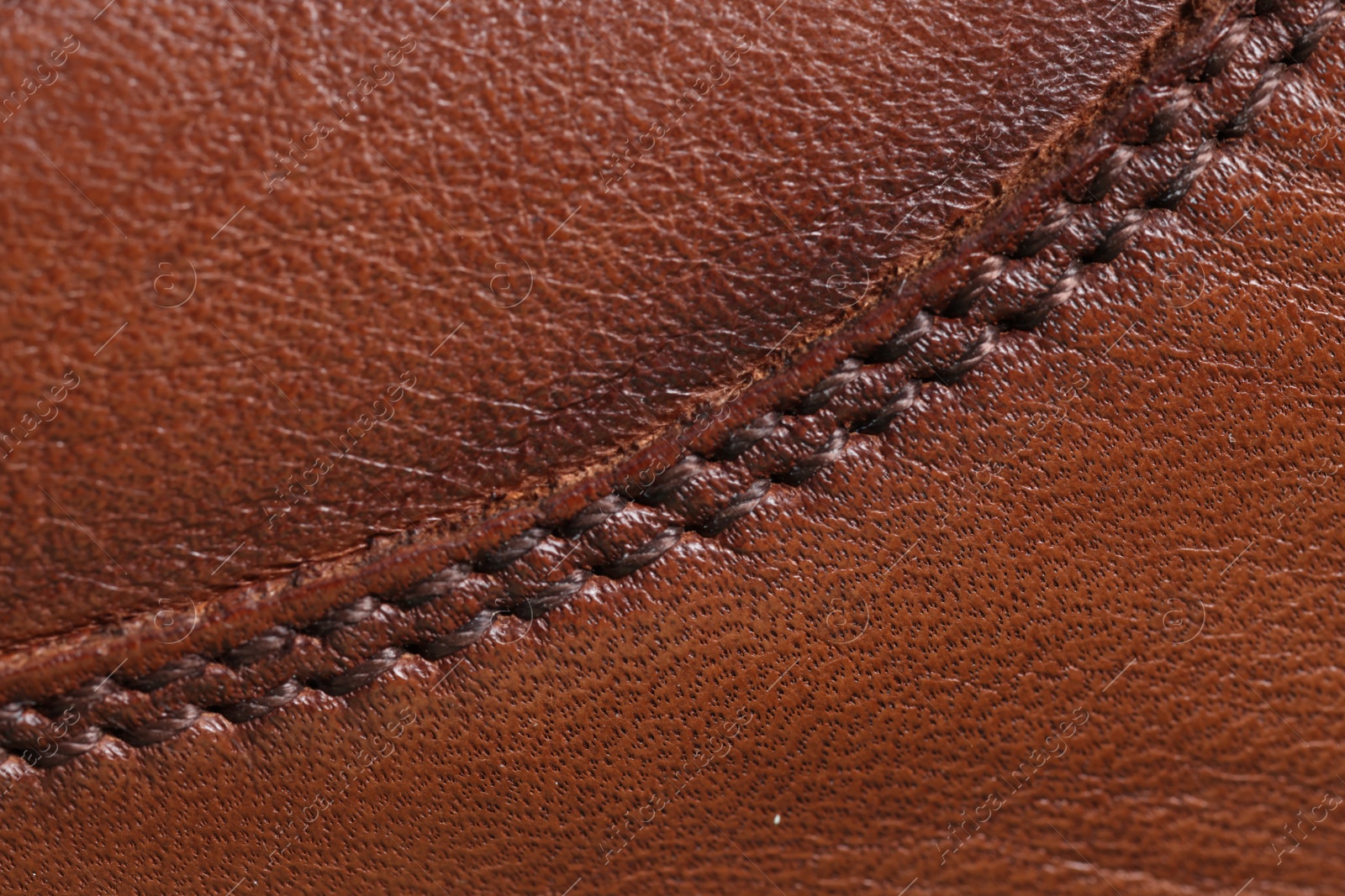 Photo of Brown natural leather with seams as background, top view