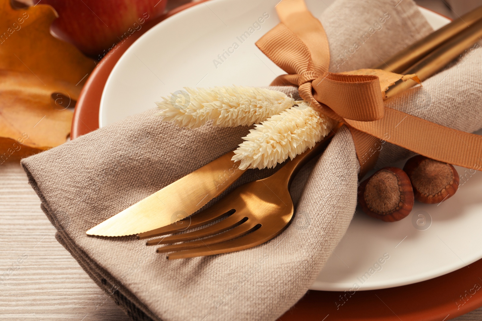 Photo of Festive table setting with autumn decor on wooden background, closeup