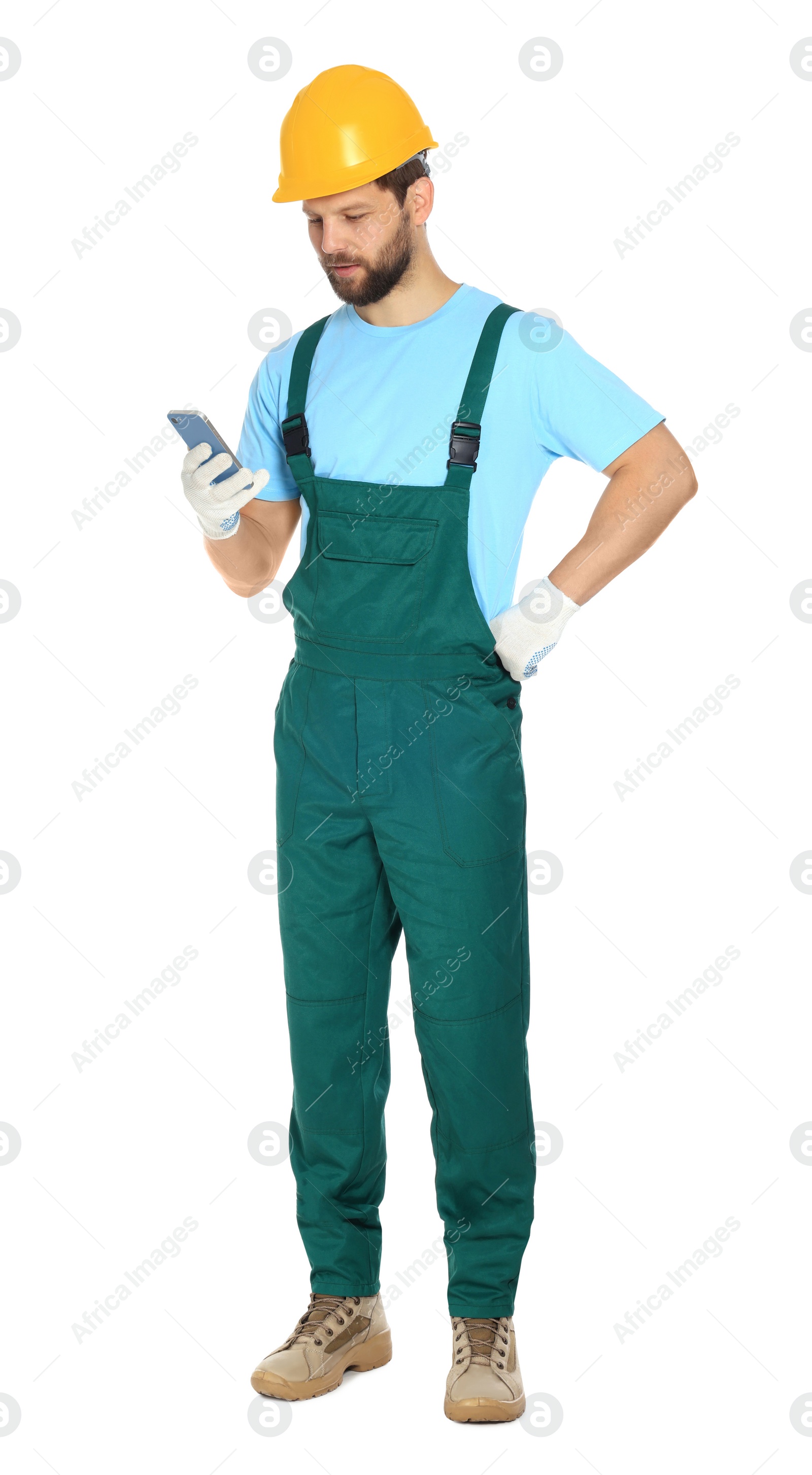 Photo of Professional repairman in uniform with smartphone on white background