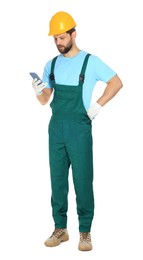 Professional repairman in uniform with smartphone on white background